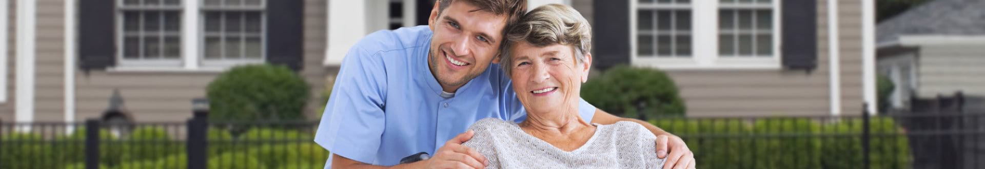 senior woman with male caregiver smiling